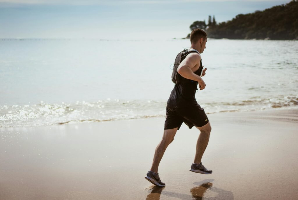 Man running at the edge of beach