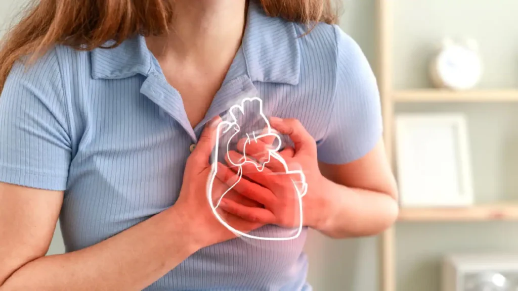 Women holding her chest with both hands with pain in heart